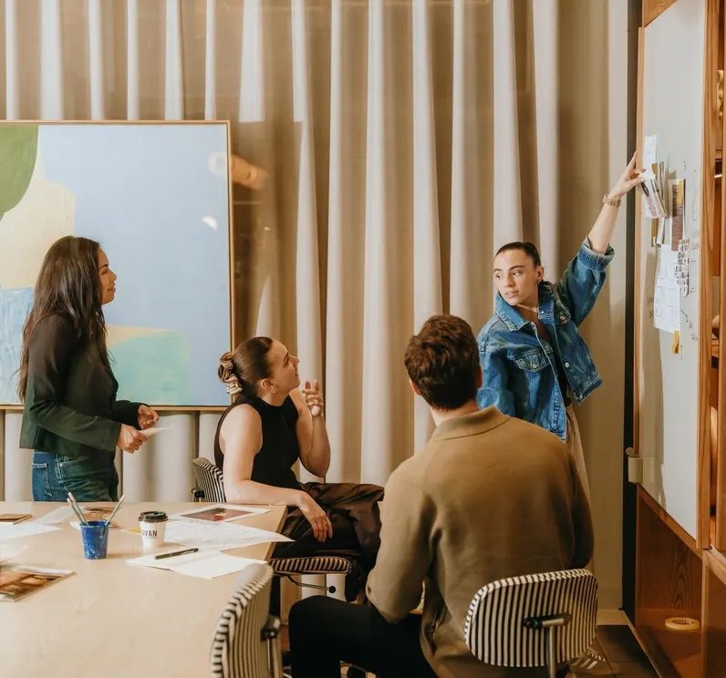 Team reviewing notes on a wall